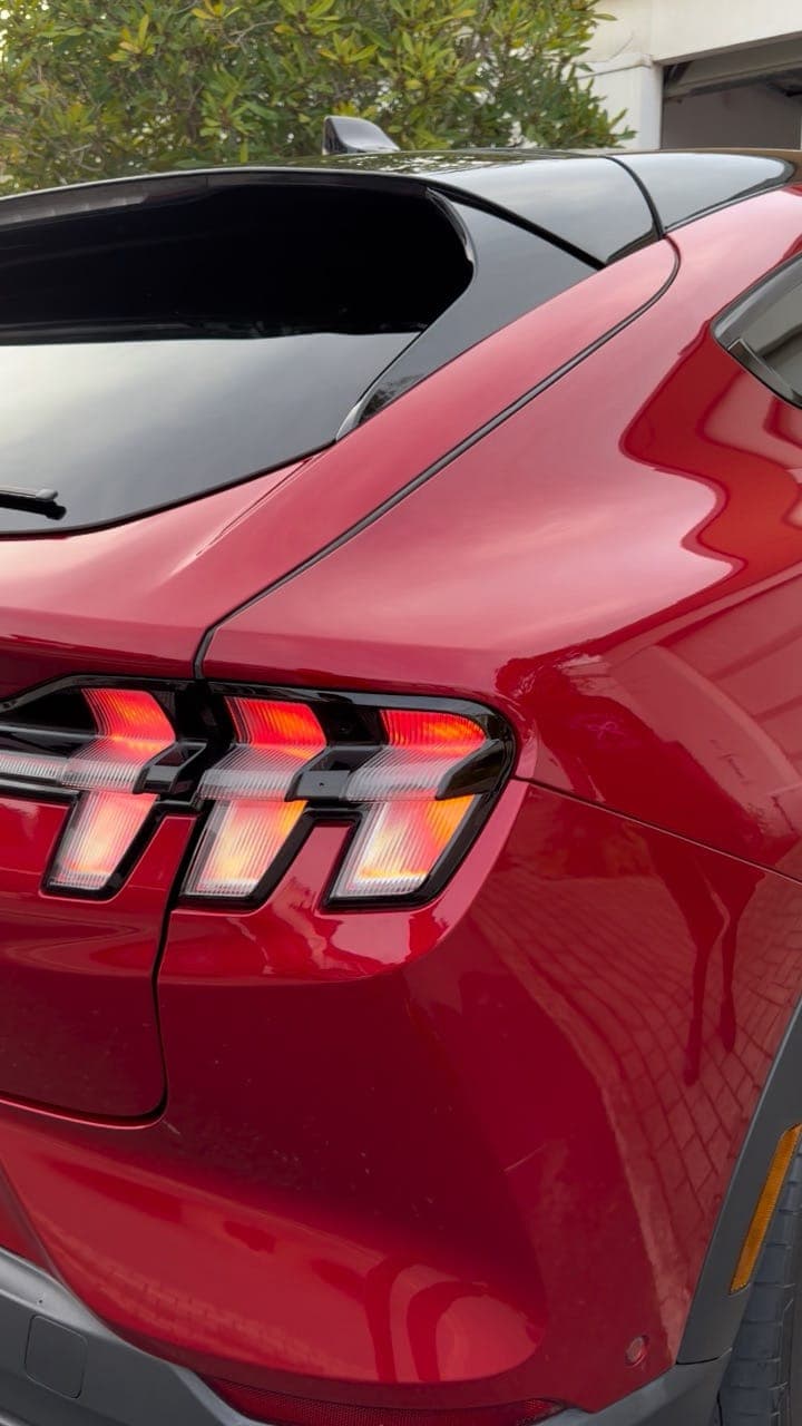 Red Mustang Mach-E rear quarter gleaming after a full detail