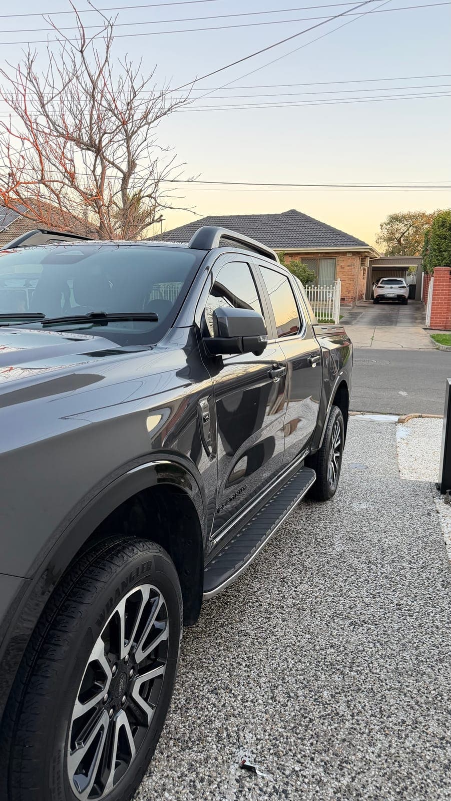 Grey Ford Ranger Platinum front three-quarter at dusk