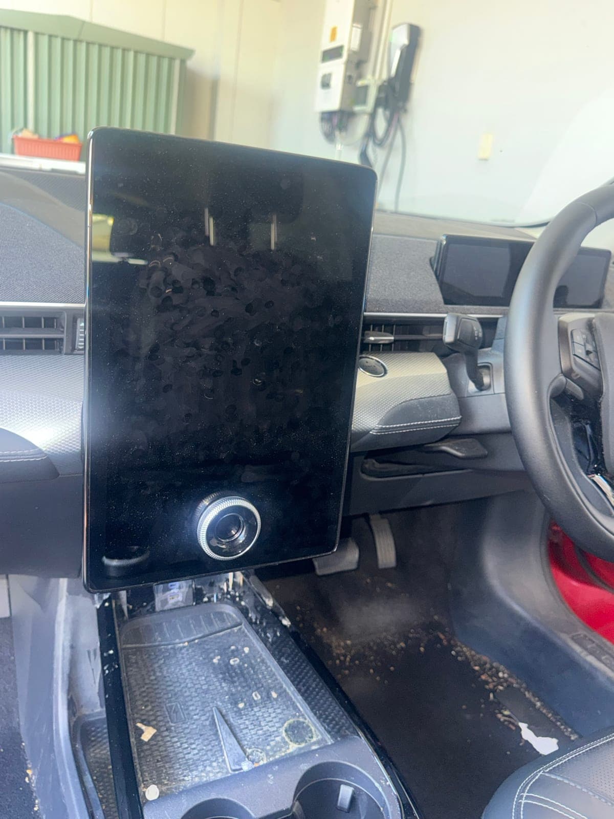 Before: dusty touchscreen and console before an interior detail
